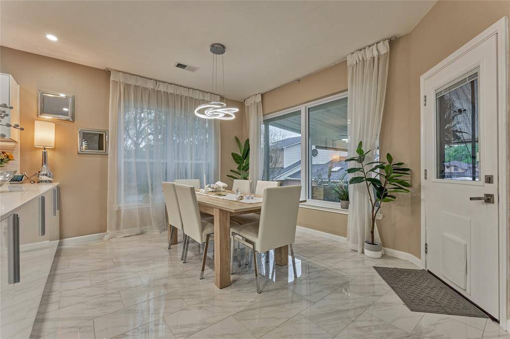 Spacious dining area with statement lighting.
