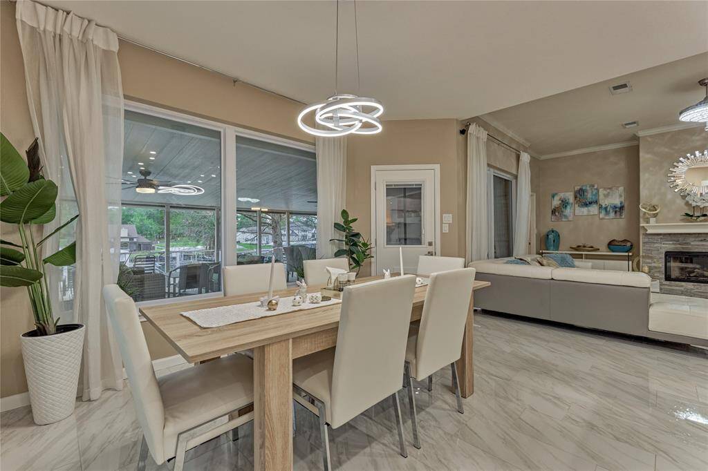 The elegant dining room enjoys peaceful water views and outdoor access to the newly updated and extended back deck.