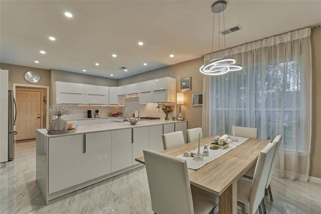 Open kitchen and dining room with abundant natural light flowing through.