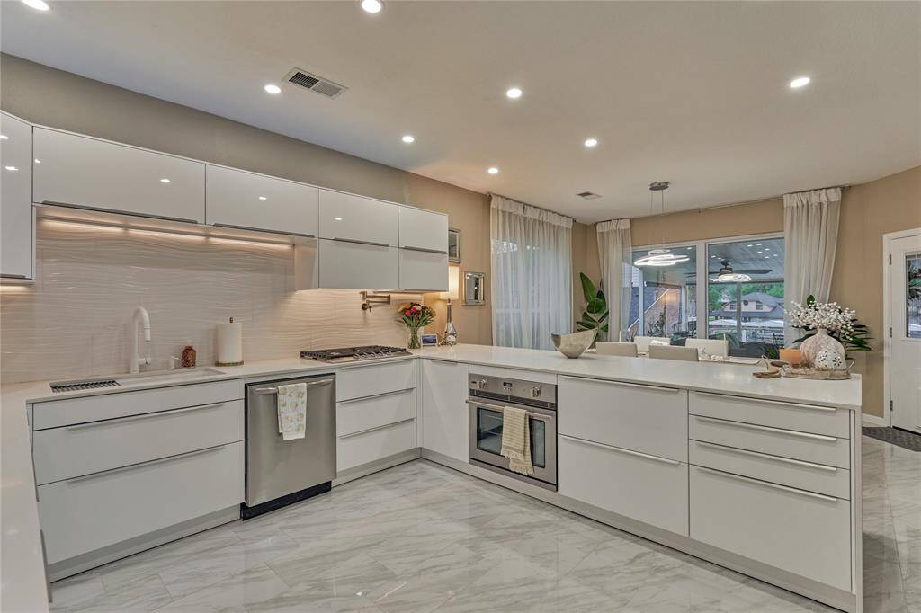 The sleek stainless appliances include a 5-burner gas stove, a new sink and faucet and a Summit Italian oven.