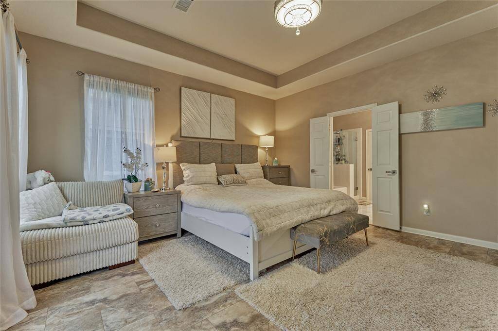 The primary suite is a private oasis with it's neutral tones and calming color palate.