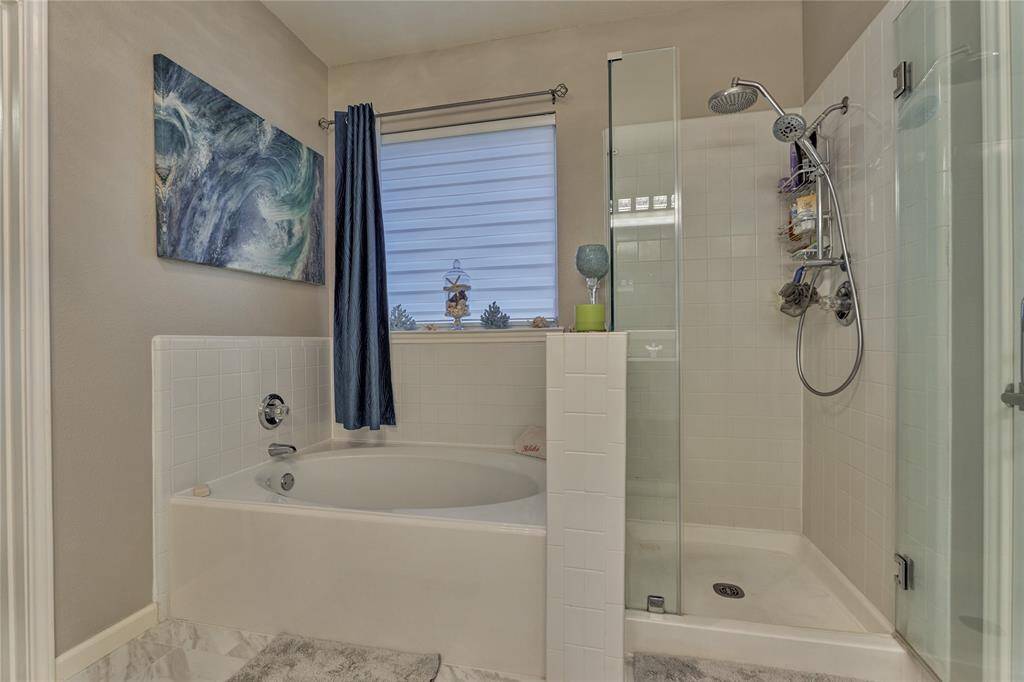 Experience a spa-like Zen atmosphere with the relaxing soaker tub and updated frameless walk-in shower.