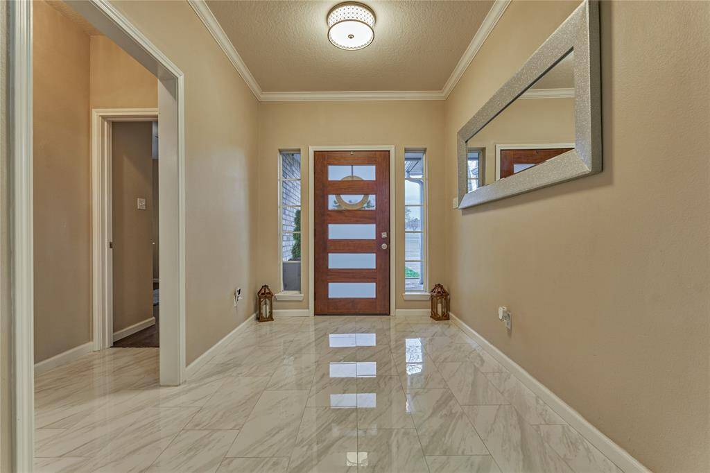 Upon entering and to the right is a private hall entrance leading to two secondary bedrooms and a shared bath.