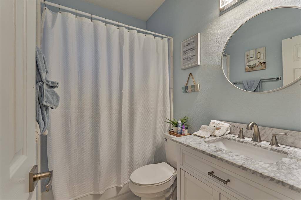 The elegant hall bath that is shared with the secondary bedrooms.