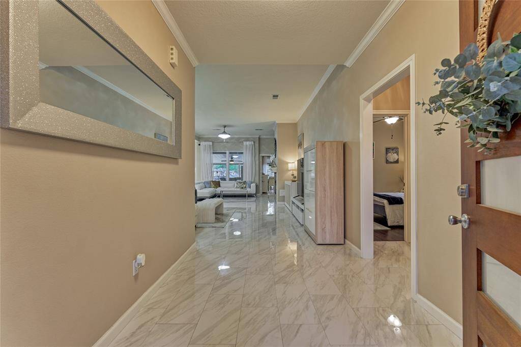 Upon entering you will notice all of the finishes to be quite sophisticated and striking, starting with the tile flooring.