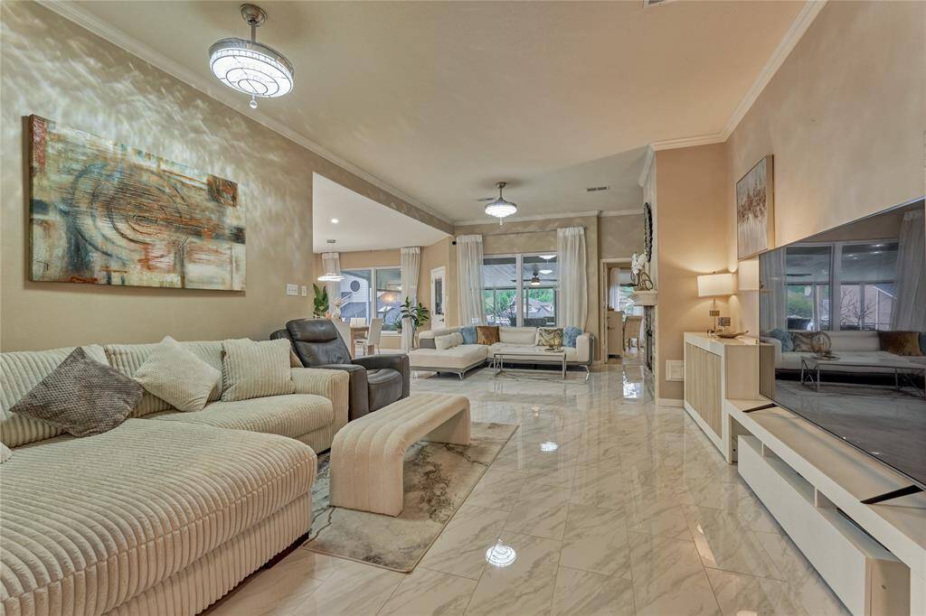 The family room and beyond abounds with luxurious design elements. Exquisite lighting illuminates all of the elegant spaces.