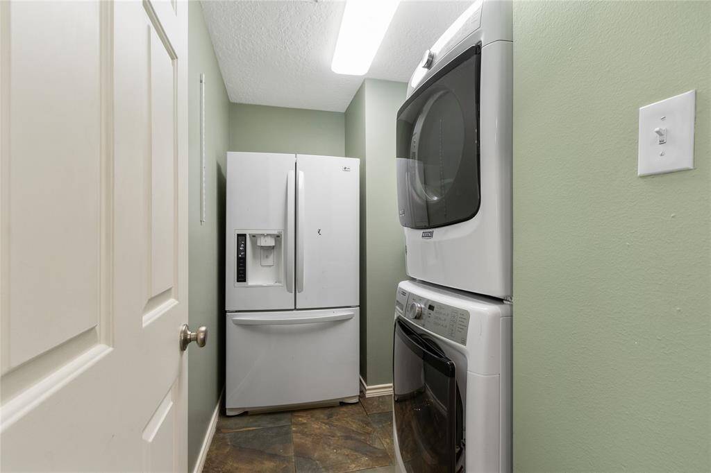 Off of the kitchen is the laundry room. Refrigerator and washer and dryer are staying as well.