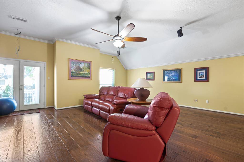 As you go up the stairs there is a large family room that overlooks the backyard oasis. The door leads to an upstairs covered patio.