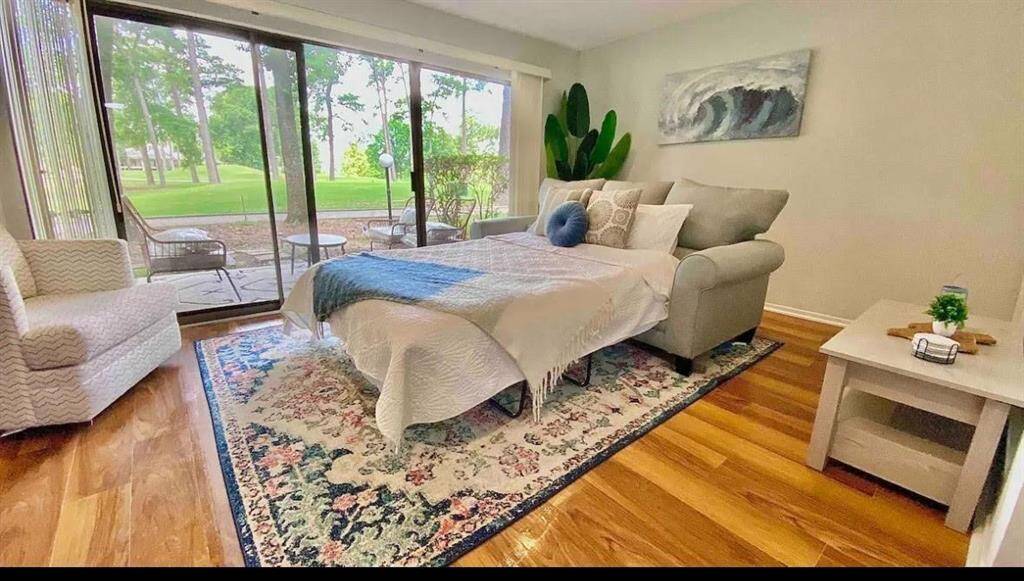 Lots of natural light, wood-look floors, and a sofa bed along with all furnishings and decor.