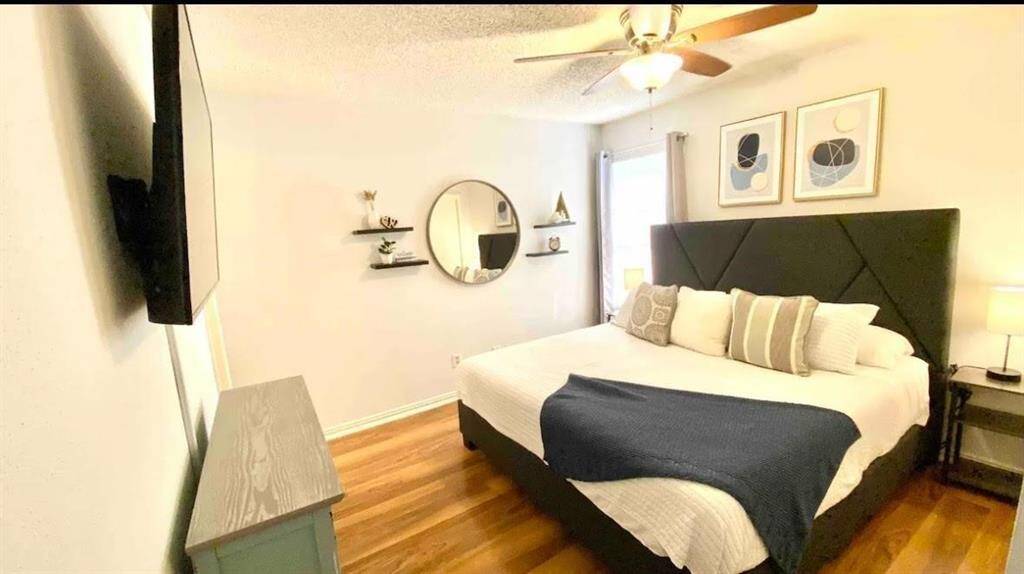 Bedroom comes with King bed, night stands, television and decor.
