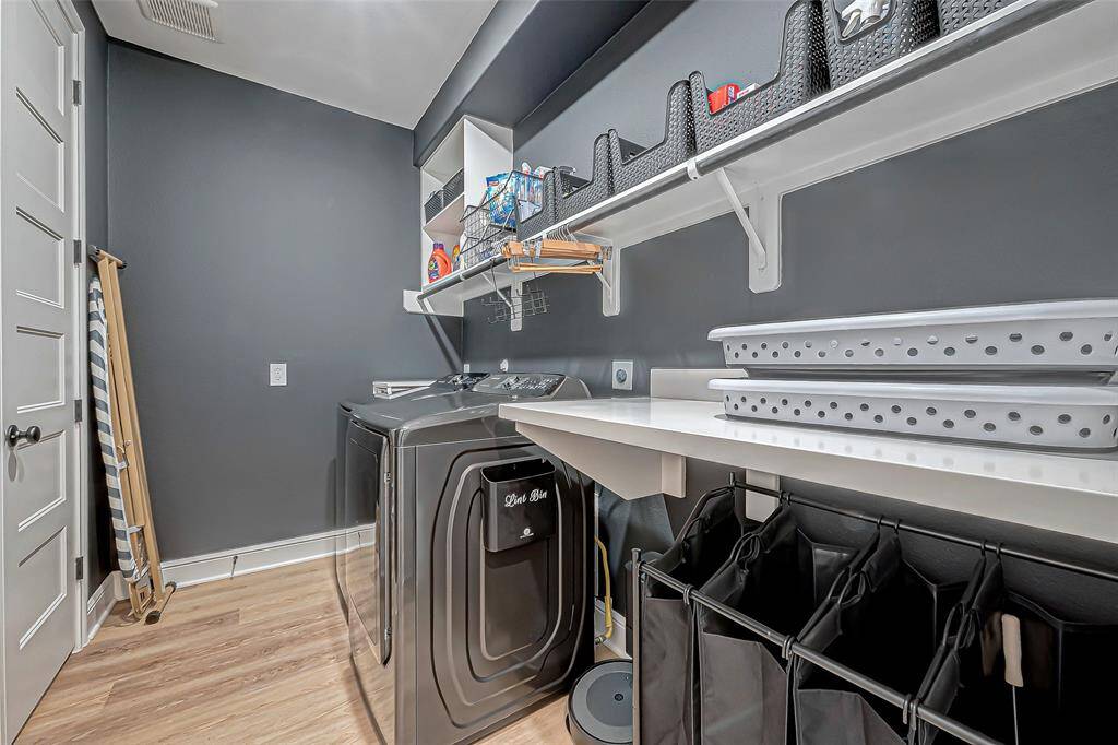 The spacious laundry room is conveniently located within the house, offering both practicality and comfort.
