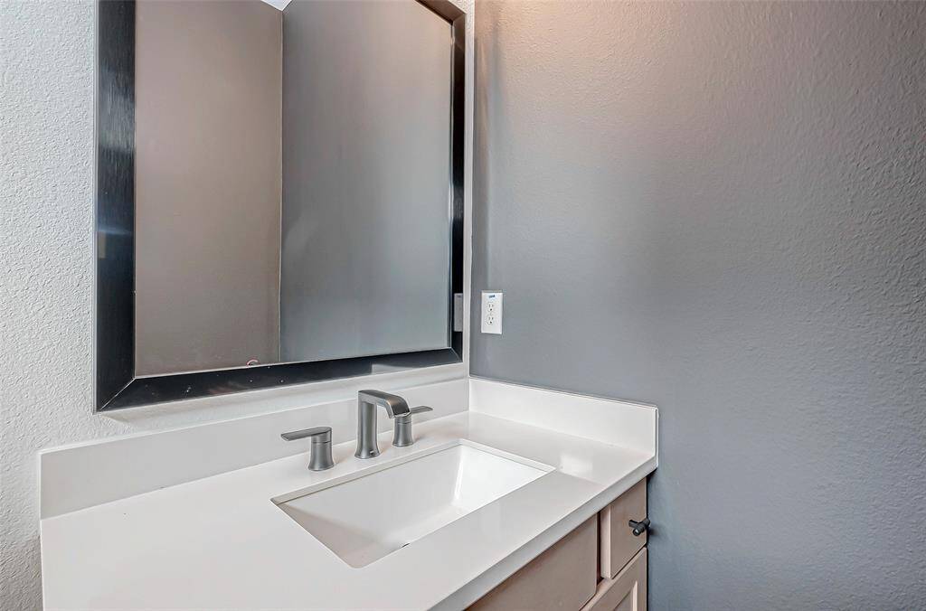 The secondary bathroom is designed for both convenience and comfort, featuring a spacious full-entry shower. Modern fixtures and a sleek design create a clean, stylish atmosphere, while the ample space in the shower ensures a comfortable experience.