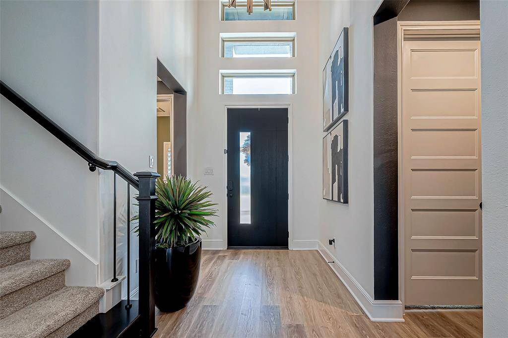 Step into the inviting foyer of this home, where warmth and elegance greet you.