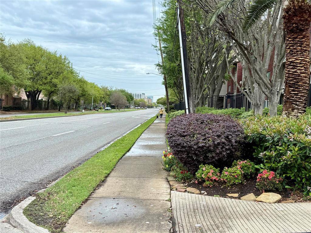 View down Old Spanish Trial in front of the entrance to City Plaza condos