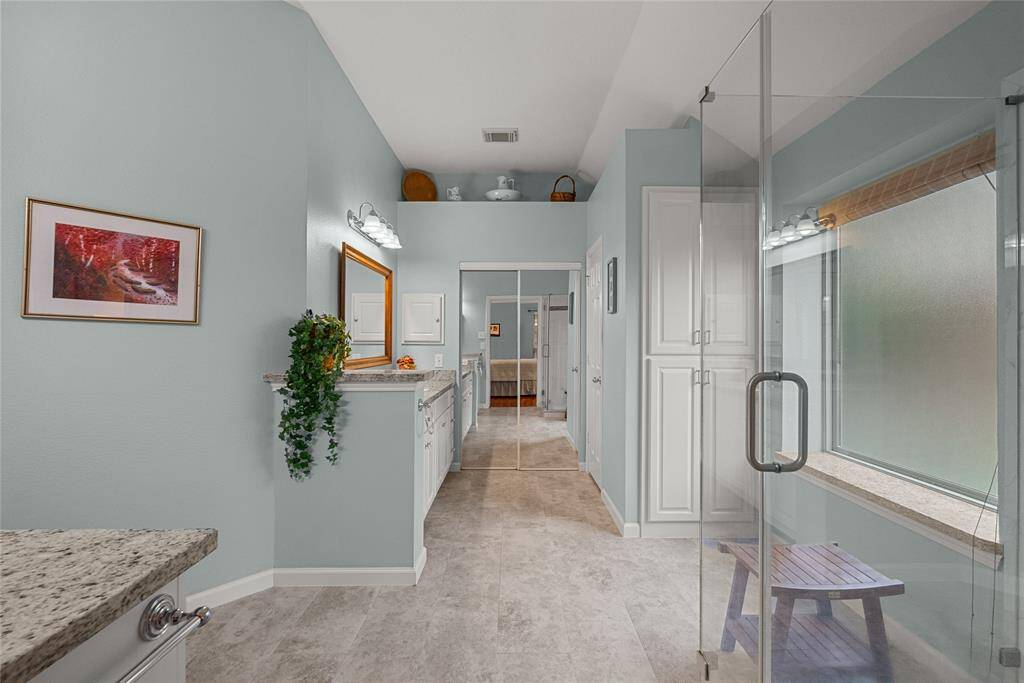 Large Primary Suite Bath has Updated Large Walk-in Shower and Vanities