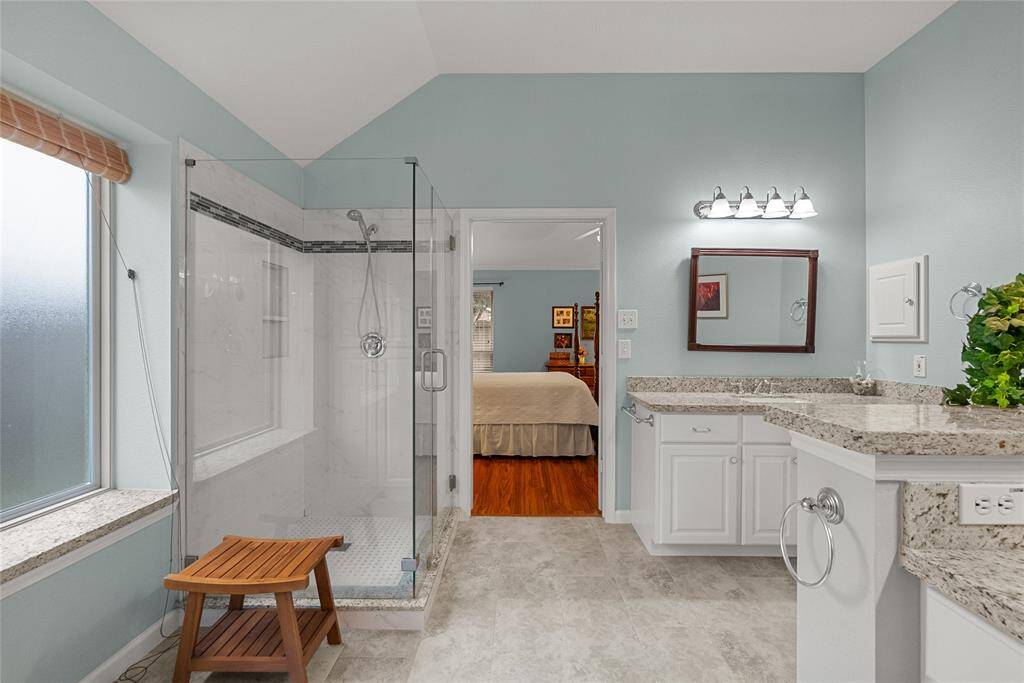 Large Primary Suite Bath has Updated Large Walk-in Shower and Vanities