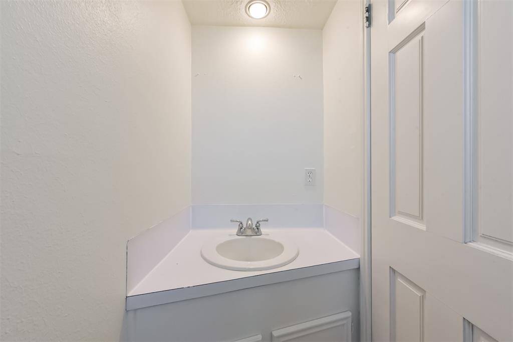 The half bathroom is located in the utility room.