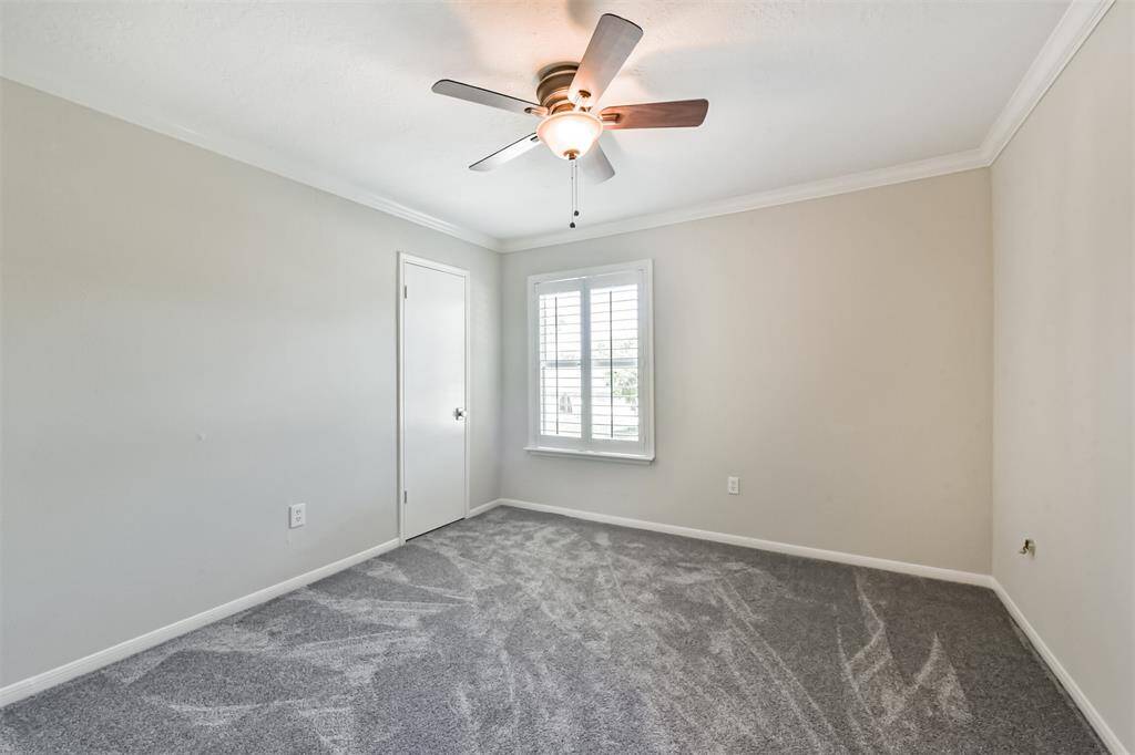 Bedroom #2 has a ceiling fan, recent carpet floors, crown molding, plantation shutters and a nice size closet.