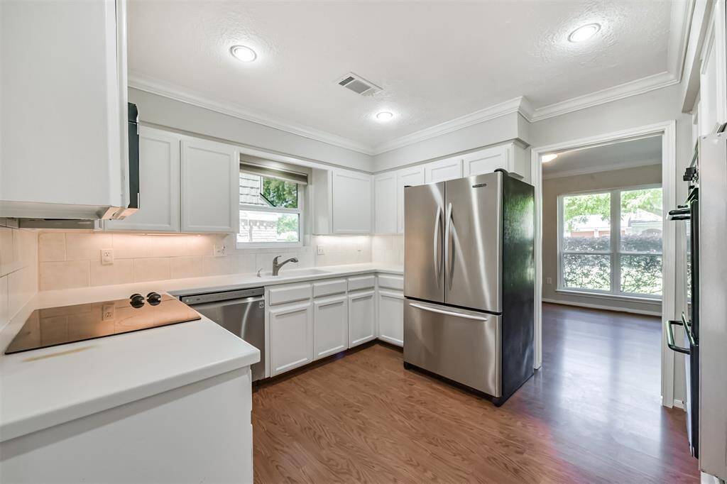There is a SS dishwasher, double basin sink and SS refrigerator in the kitchen.