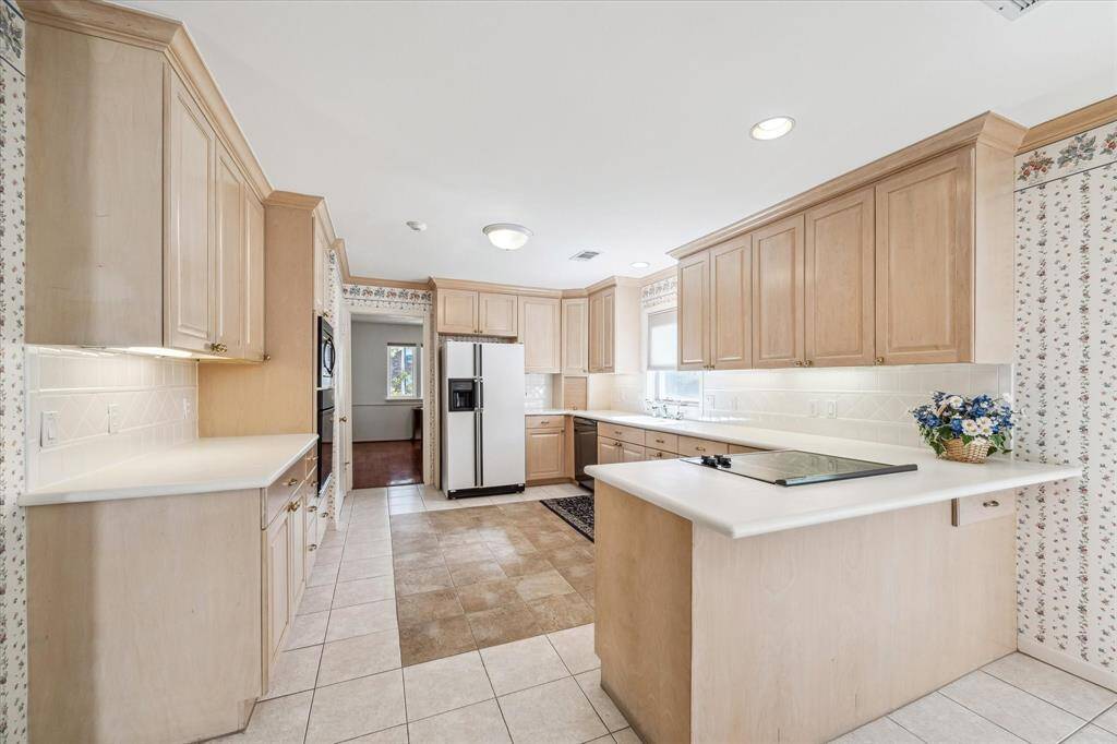 Homeowners were forward thinking when they remodeled this Kitchen in 1995. They installed soft close, extended drawers for ease of use, Lazy Susan's in the corner cabinet and an appliance garage with a plug inside.