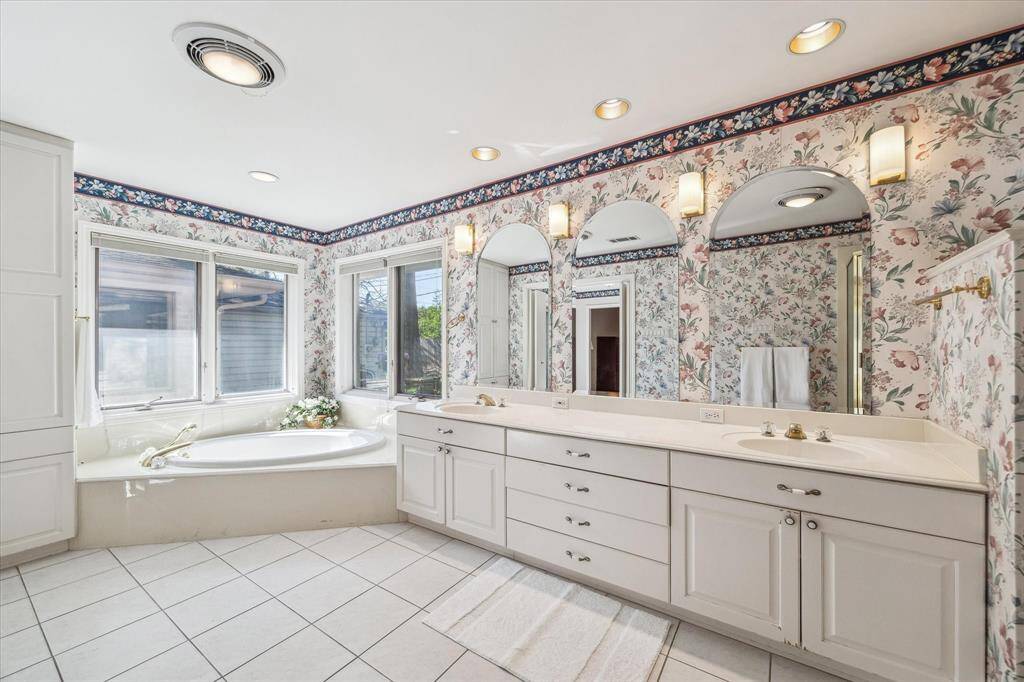 Primary Bathroom has recessed cans, double sinks, corner shower and jetted tub.