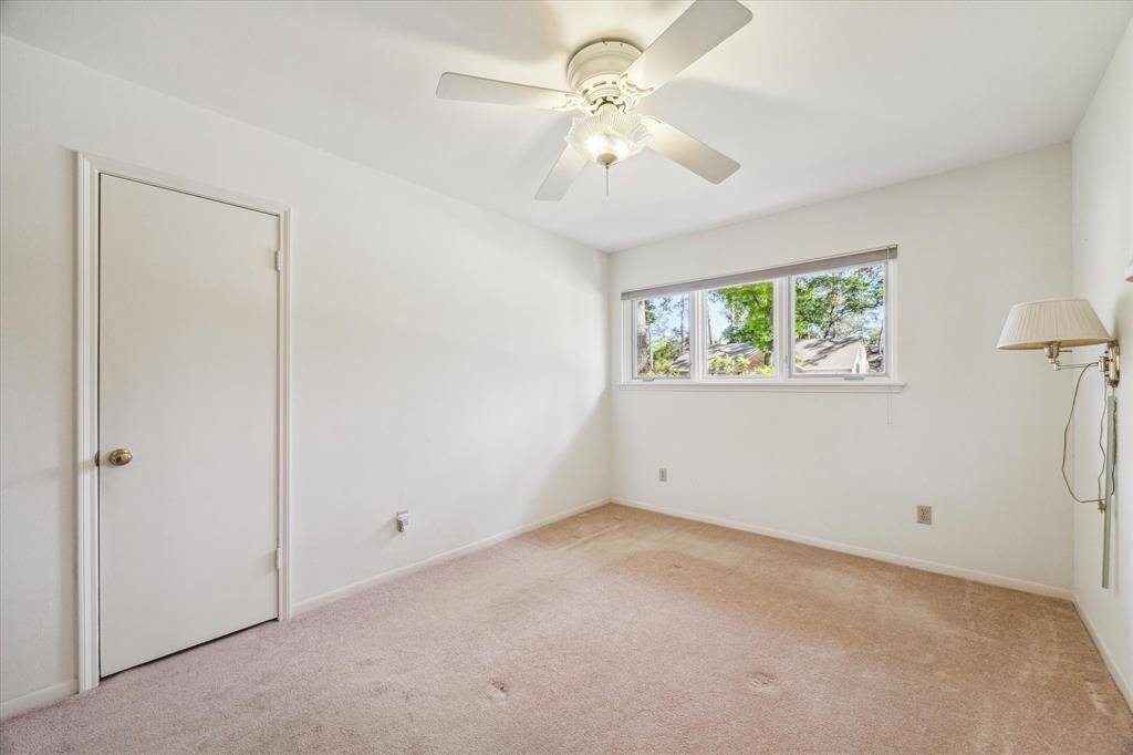 Fourth bedroom has ceiling fan, large closet and 2 wall sconces. It is located on the front of the house.