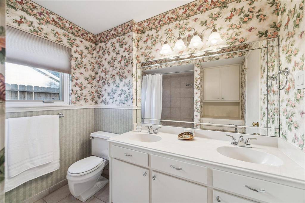 Secondary bathroom has 2 sinks and tub/shower combo. Notice the nice built in area that provides extra storage.