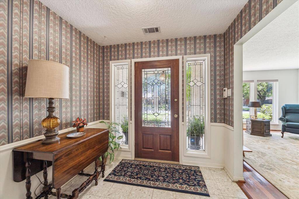 Front door with sidelights makes for a spacious and inviting entry.