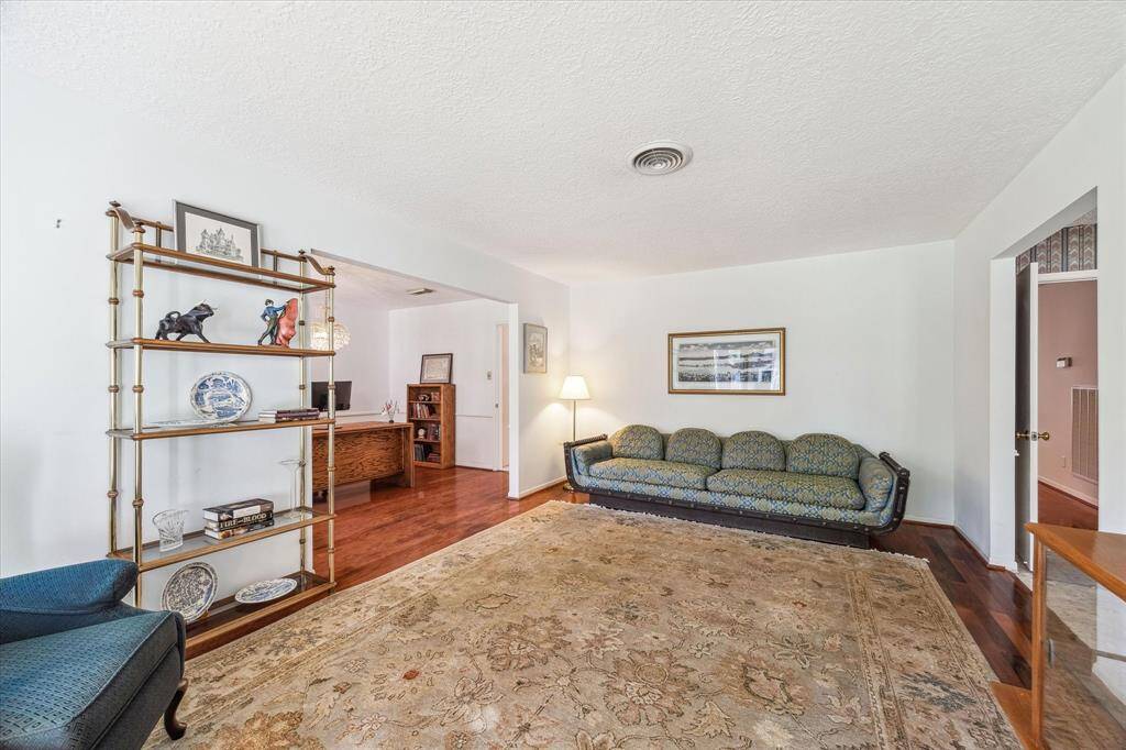 Formal Living Room, on the front of the house, has wood floors and is open to the original Dining Room.