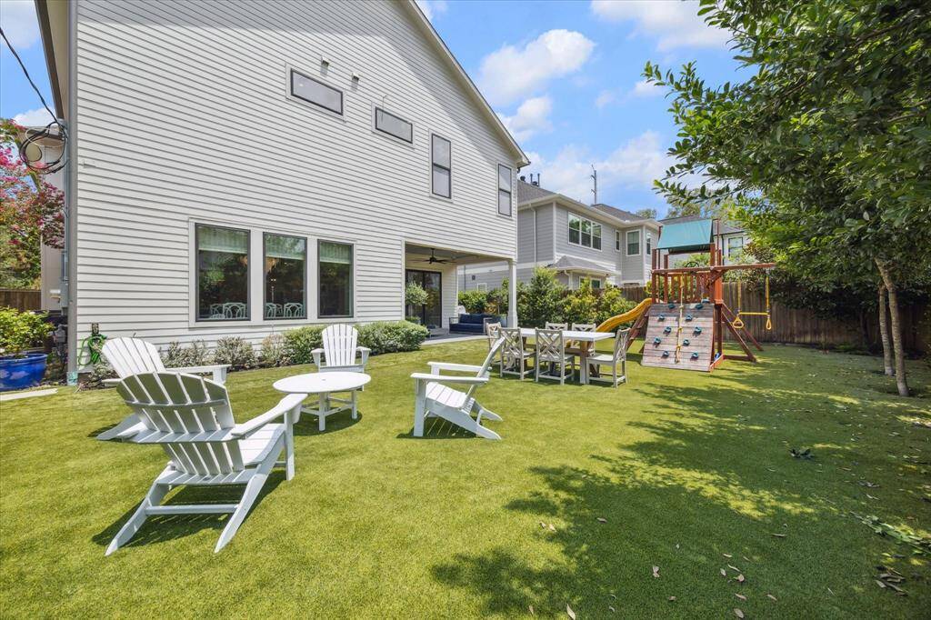 The charming covered front porch offers welcoming appeal, and enhances the home's timeless design, providing a cozy seating area with lantern lighting above.