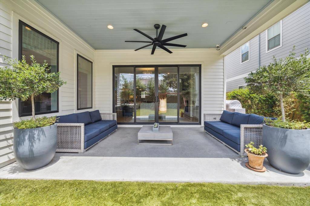 Through sliding glass doors, the large covered patio is an extension of the living room and features a large ceiling fan, recessed lighting and mosquito system.