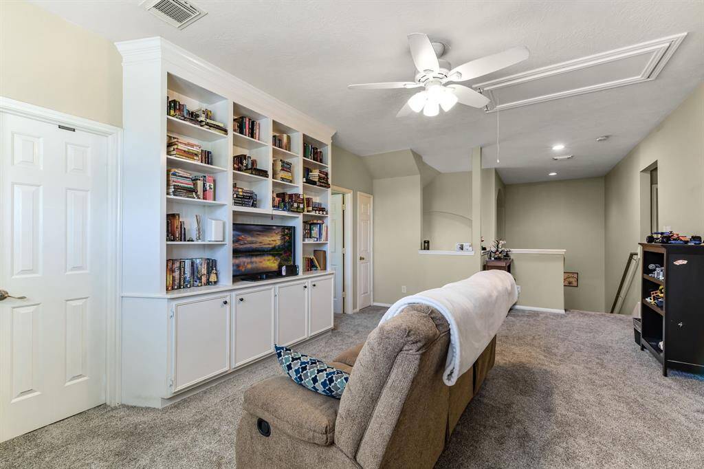 Welcome to the upstairs game room, a versatile space designed for fun and relaxation. The room features elegant white built-in cabinets, offering ample storage for games, books, and entertainment essentials. Whether it’s a cozy movie night or a friendly game of cards, this room provides the perfect backdrop for making memories and enjoying quality time.