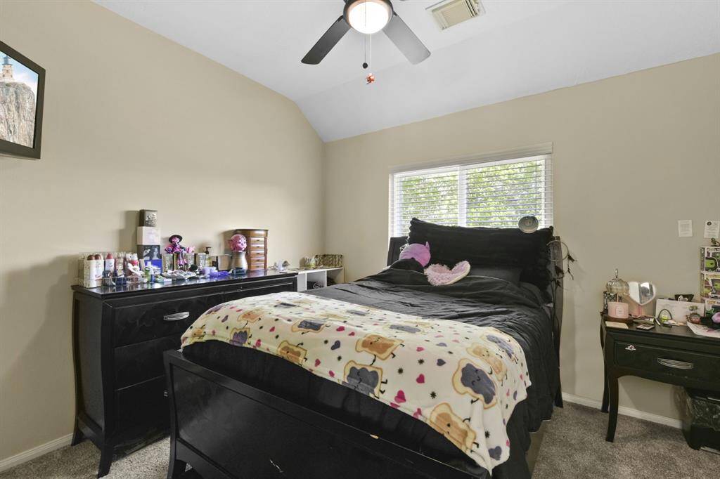 This secondary bedroom is filled with potential, offering a comfortable and serene environment. With plenty of room for furnishings and personal touches, it provides an ideal space for relaxation, a home office, or a cozy retreat. The neutral palette and natural light create a welcoming atmosphere for whatever purpose you envision.
