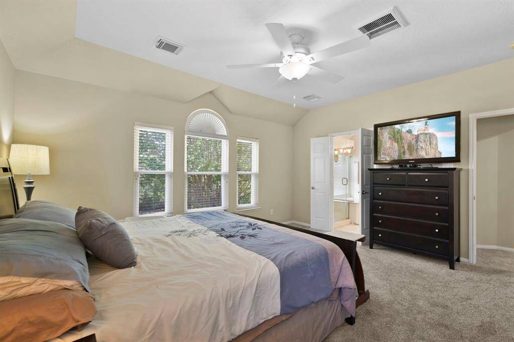 Step into this expansive primary bedroom, designed with comfort and tranquility in mind. The room features plenty of space for rest and relaxation, with French doors that seamlessly lead into the luxurious primary bathroom. A serene retreat, perfect for unwinding after a long day, with ample room to create your own personal oasis.