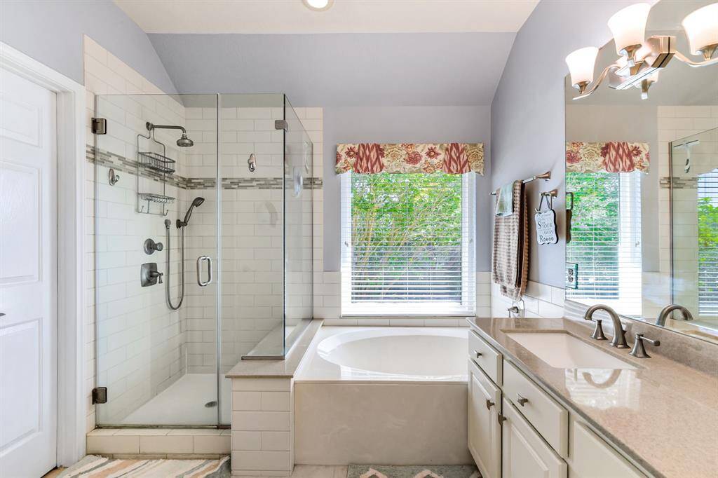 Take in the elegance of this primary bathroom, where a sleek seamless shower becomes the focal point of the space. The shower’s modern design, paired with high-end finishes, creates a clean and open feel. With its minimalist look and seamless integration, this bathroom offers both luxury and functionality for the perfect daily retreat.