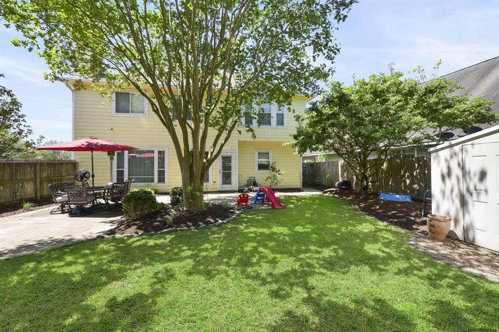 Step outside to a spacious backyard offering plenty of room for outdoor activities and relaxation. The expansive patio is perfect for entertaining or enjoying a quiet evening, while mature trees provide ample shade to keep you cool on warm days. Whether hosting gatherings or simply unwinding in the fresh air, this backyard is designed for comfort and versatility.