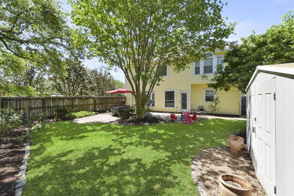 Discover the convenience and versatility of this spacious backyard, complete with a practical storage shed for all your outdoor tools and equipment.