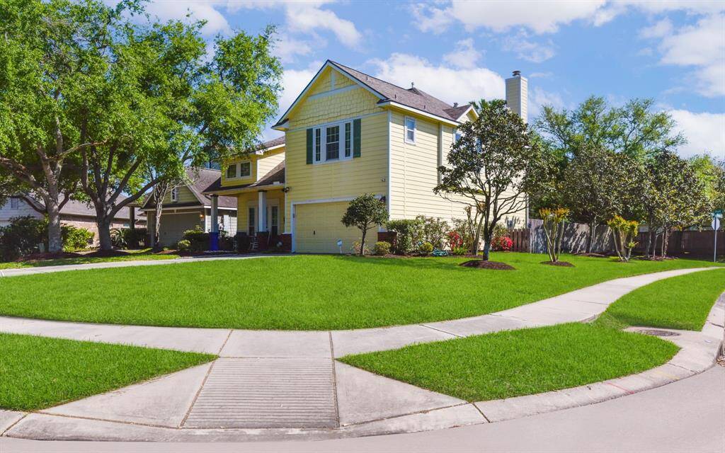 Beautiful corner lot home with views of the tranquil neighborhood lake. This elevated position offers both privacy and picturesque scenery, with lush landscaping framing the sparkling water. Enjoy peaceful mornings and stunning sunsets from your front yard or patio—perfect for relaxing or entertaining with a view.