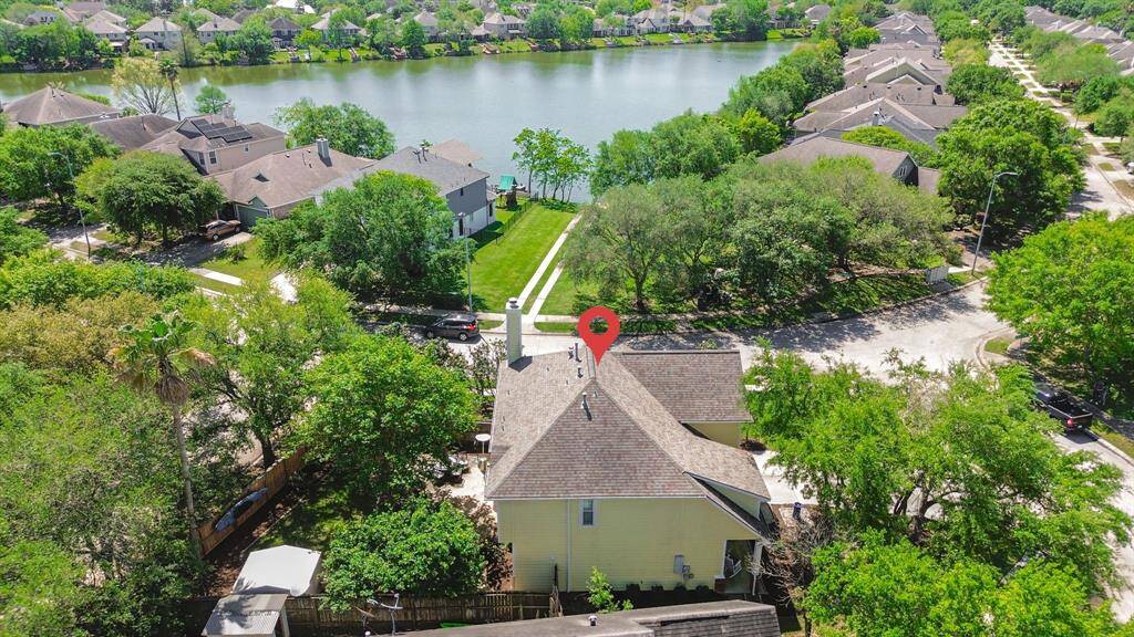 Take in the stunning aerial view of the house, ideally located just across the street from the neighborhood lake. The serene waters offer a picturesque backdrop, visible from the home’s front view. This aerial perspective highlights the close proximity to the lake, providing a peaceful and scenic setting right outside your door.