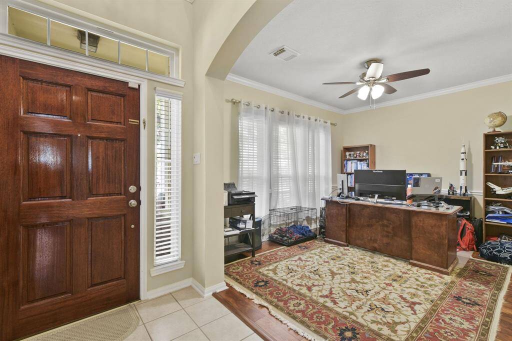 This versatile formal area, currently set up as a home office, features neutral tones, clean lines, and soft natural light. It’s a flexible space that can easily transition into a dining area, sitting room, or creative flex space to fit your lifestyle.