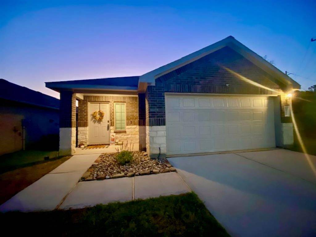 Charming single-story home with a brick exterior and a welcoming front porch. It features a two-car garage and a neatly landscaped front yard. Perfect for comfortable, suburban living.