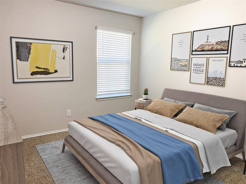 A cozy bedroom with neutral tones, with room for full size bed, ready for your personal decor and style.   A window provides natural light, with space for a small side table and neutral textured carpet.