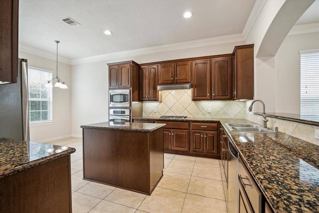 Gourmet fabulous kitchen boasts of endless granite countertops, stainless steel appliances, ample cabinet & storage space with undermount lighting.
