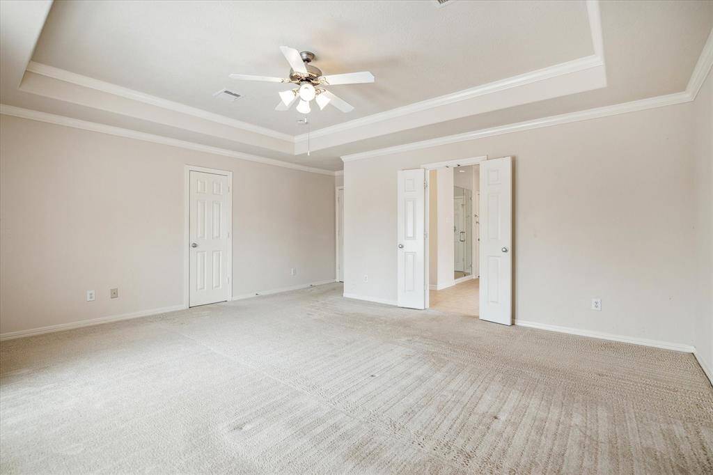 The primary bedroom serves as the perfect retreat for relaxation, offering both comfort and convenience with direct access to its private en-suite bath and spacious walk-in closet.