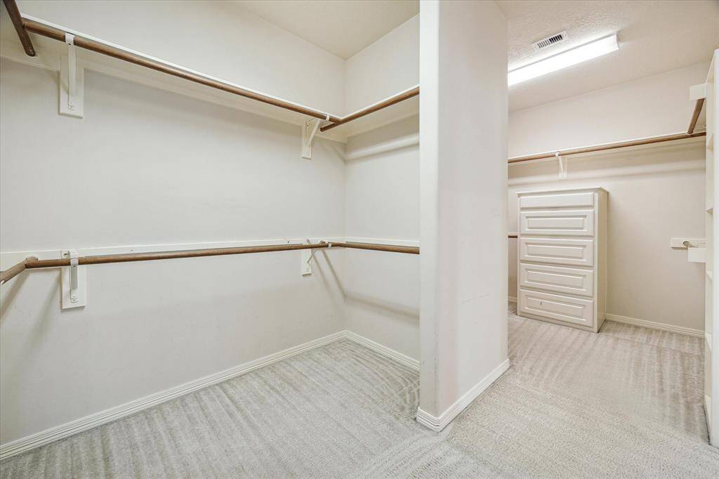 The walk-in closet, accessible from the primary bath, offers generous hanging space and ample storage, making it ideal for organizing all your wardrobe essentials with ease and efficiency.