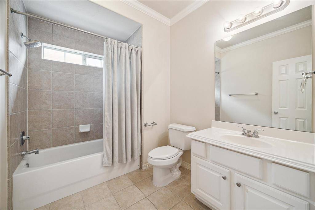The shared bath between the second and third bedrooms features a tub-shower combo, a well-appointed vanity with overhead lighting, and generous counter and storage space—perfectly blending style and functionality.