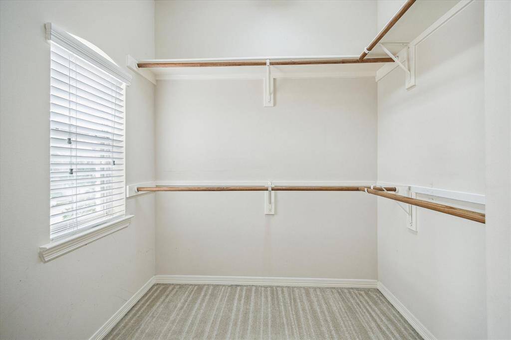 The spacious walk-in closet offers abundant hanging and storage space, providing a well-organized and functional area for all your wardrobe essentials.