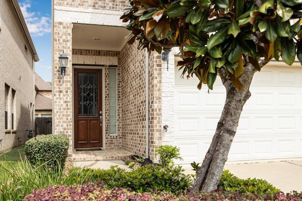 Step into a world of timeless elegance through the charming courtyard entrance, adorned with Old World style brickwork and accent stone walls that exudes character and sophistication.
