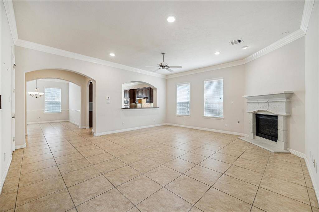 The generously sized main living room offers as the centerpiece a stunning tall cast stone fireplace, meticulously crafted to exude grandeur and sophistication.
