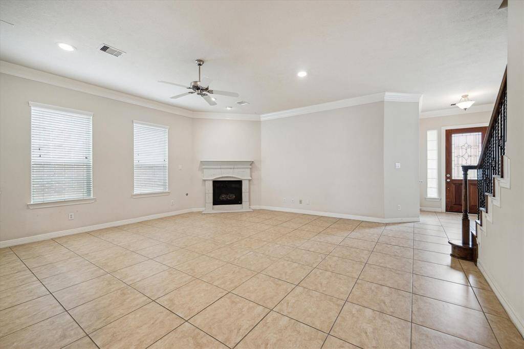 The main living area is adorned with soaring ceilings, a soothing neutral palette, and elegant flooring, creating the ideal space for both relaxation and entertaining.